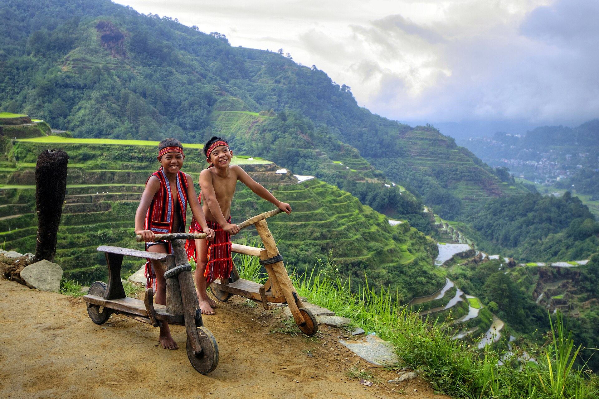 Ifugao children with wooden scooters at Banaue